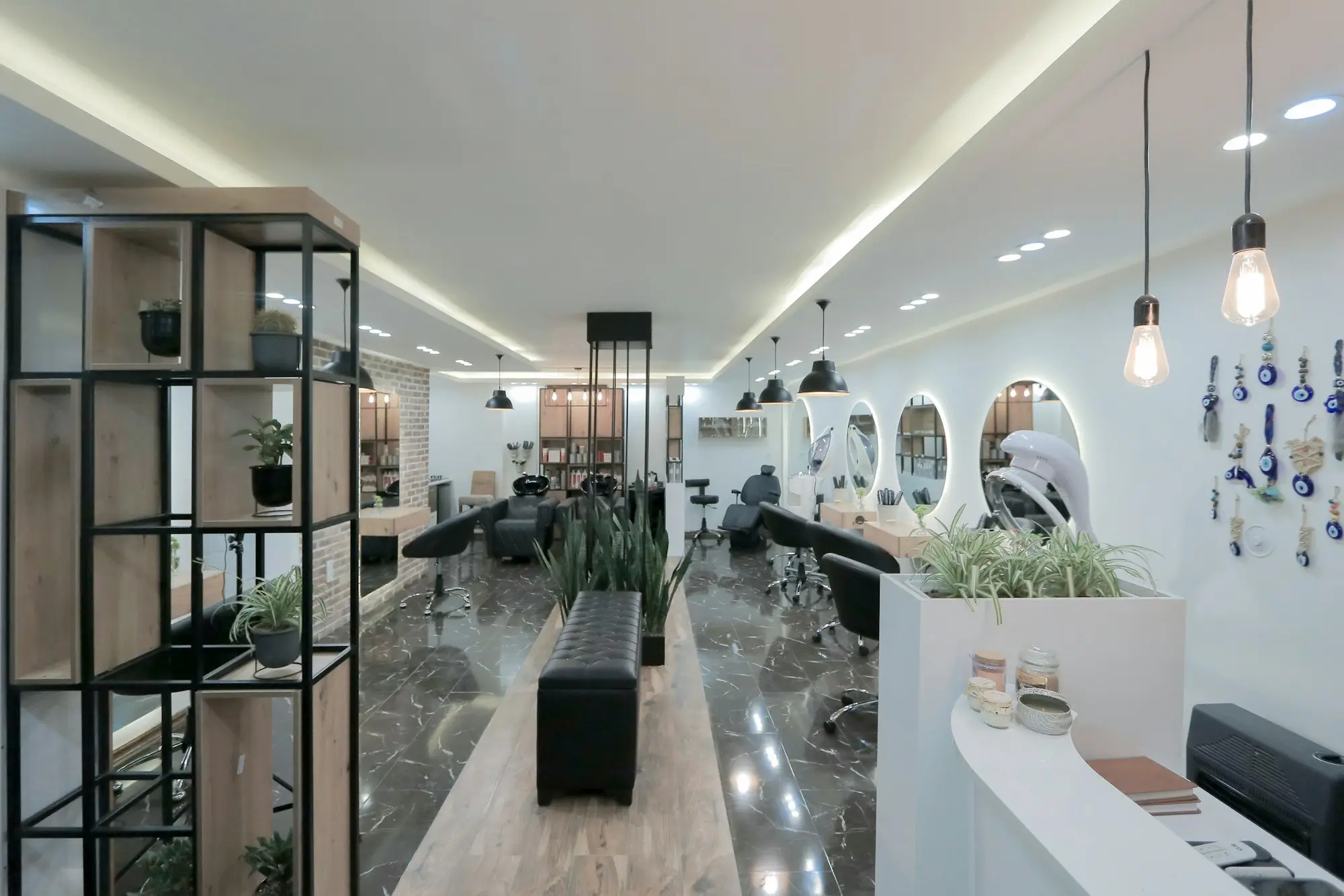 Peluquería y estética en Santa Isabel, Zaragoza | Christian Peluqueros Interior luminoso de una peluquería con sillones, espejos y buena iluminación: peluquería y estética en Santa Isabel, Zaragoza